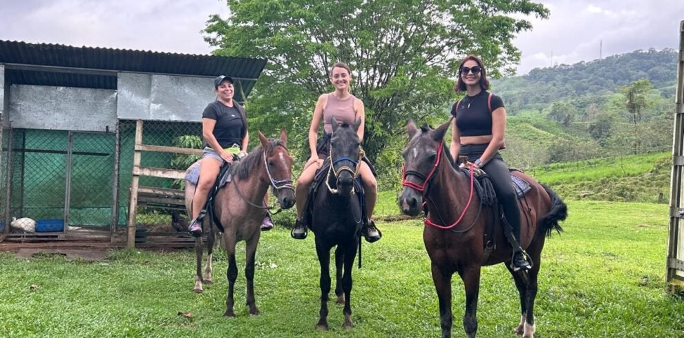 Three young people on a horseback riding tour in Costa Rica's lush countryside